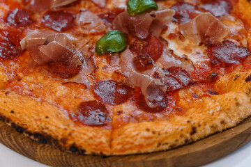 Pizza with salami and prosciutto. Meat pizza with cheese