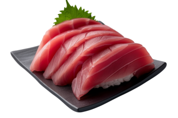 Freshly prepared tuna sashimi slices served on a black plate garnished with wasabi and a shiso leaf perfect for a gourmet meal.
