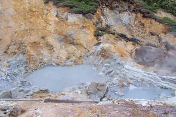 Steaming Hot Spring Pool in Volcanic Landscape of Goshougake Onsen, Akita, Japan
