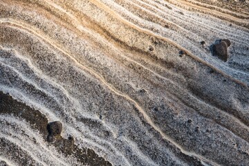 Stunning colorful structured stone pattern created by erosion. Detailed view of the structured sandstone of the 'painted cliffs' on Maria Island, Tasmania, Australia.  Maria Island National Park.
