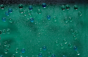 Bubbles and water drops on green