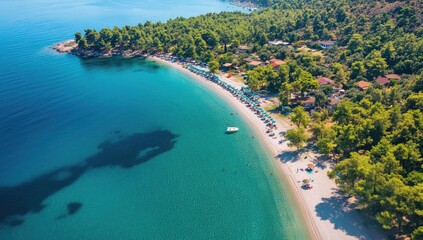 Aerial View of Serene Blue Sea and Clear Sky Over a Peaceful Beach with Mountains in the Background on a Summer Day