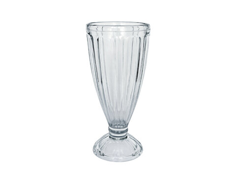 Empty clear milkshake glass isolated on a white background with clipping path. Transparent tall glass cup mockup for cold drinks and ice cream sundae.
