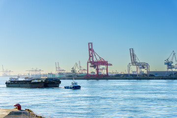 Obraz premium Sailing ships through Osaka port , Marine cargo, large port city and commercial center on the Japanese island of Honshu, Osaka, Japan.