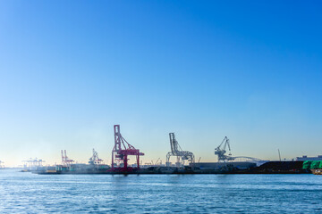 Fototapeta premium Large cranes at Osaka port, Marine cargo, large port city and commercial center on the Japanese island of Honshu, Osaka, Japan.