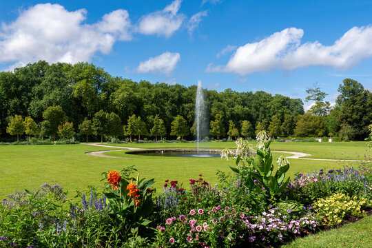 Rambouillet, France - August 15 2024: Fountain in the Domain of Rambouillet with flower in the foreground