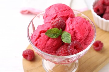 Delicious raspberry sorbet, mint and fresh berries on white wooden table, closeup