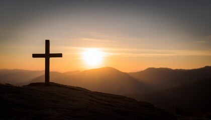 silhouette of a wooden cross stands prominently against a breathtaking sunset backdrop on a mountain. The dramatic interplay of light and shadow highlights the cross, creating a serene and sacred atmo
