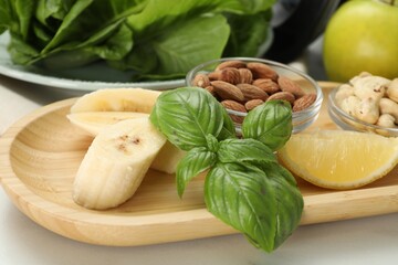 Fresh ingredients for smoothie on white marble table, closeup