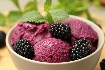 Delicious blackberry sorbet, fresh berries and mint in bowl on table, closeup