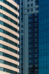 many windows and walls facade of a modern skyscraper without people