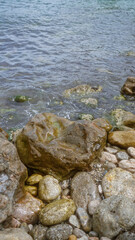 Rocky shoreline with wet stones and clear water