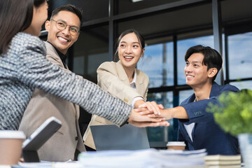 business people holding each others wrists, join hands together, support and unity, team strength and power, colleagues involved in team building activity.