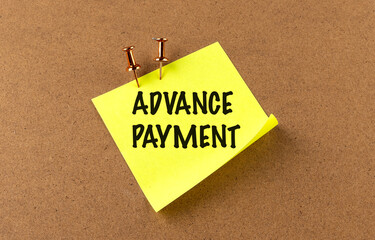 ADVANCE PAYMENT text on yellow sticky on board background
