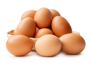 Fresh brown chicken eggs in stack in wicker basket isolated on white background with clipping path