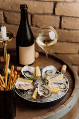 Fresh oysters on ice with lemon and wine, perfect for luxury dining experiences and celebrations