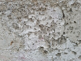 Old cement concrete wall with faded paint, grunge texture and pattern.