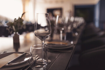 Beautifully served festive table. served table with white tablecloth. white plates, wine glass, fork, knife. luxury tableware beautiful table setting in restaurant. Table set for an event party 
