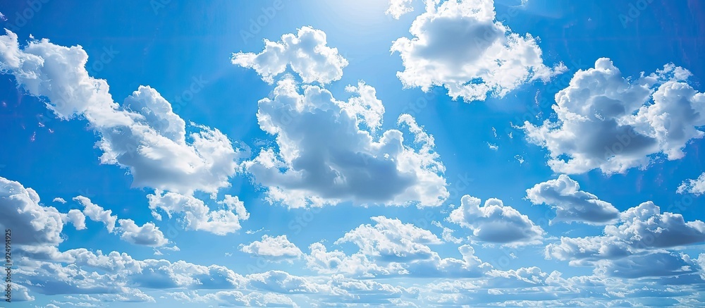Poster a large expanse of blue sky with fluffy clouds perfect for a copy space image