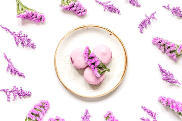 spring woman breakfast with macaroons and flowers white background top view