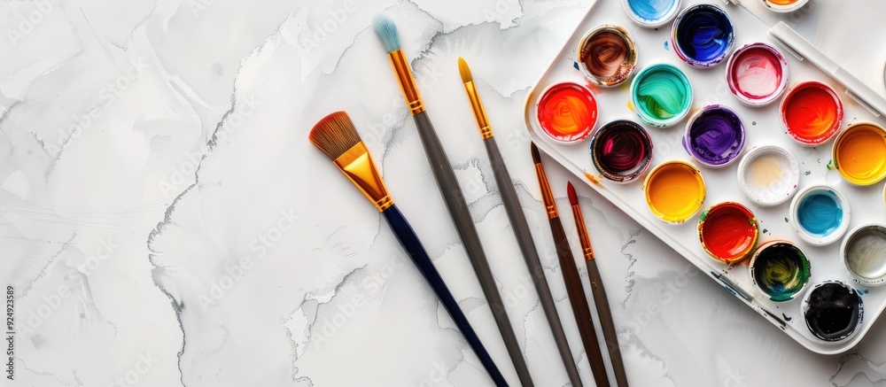 Poster Watercolor paint set with paintbrushes for creating art displayed in a visually appealing copy space image