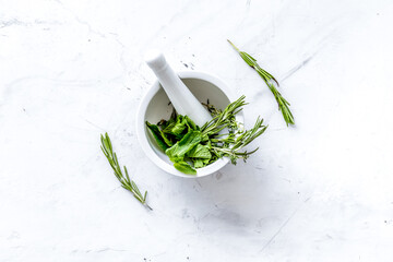 Store up medicinal herbs on white marble background top view