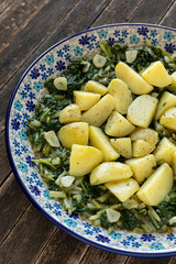 Potatoes with leaf beet and garlic on a plate. South Croatian Blitva dish made with boiled...