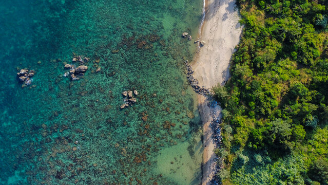 
A calm and beautiful beach with a forest next to it, in Vietnam, Asia, seen from above