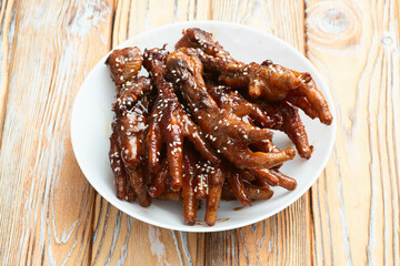 Caramelized korean or Chinese chicken foots ( paws ) with sesame . Top view