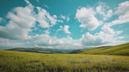 Obraz premium Scenic Countryside with Rolling Hills and Scattered Clouds Under a Tranquil Sky