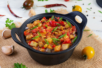 Stewed vegetables with tomato sauce and herbs. Spicy vegetable stew