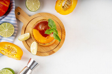 Thanksgiving Margarita, Sweet Pumpkin Shrubs cocktail, alcohol tasty autumn drink on white background with slices pumpkins, copy space