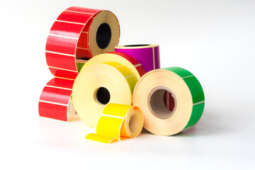 Reels of self-adhesive clean colored labels on a white background on different cores for printing...