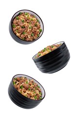 Ground meat spicy ramen noodles in a bowl on a white isolated background