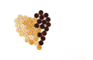 Heart from wooden buttons of different color on a white background