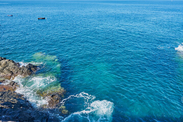 Sea foam and Atlantic Ocean waves crashing against the rocks in Los Gigantes Tenerife Spain