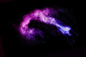 Explosion of colored powder and dust smoke splash pink and purple on black background