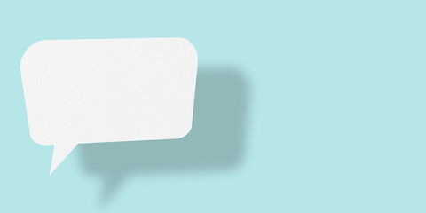 Empty speech balloon shape white paper isolated on light blue background communication bubbles.