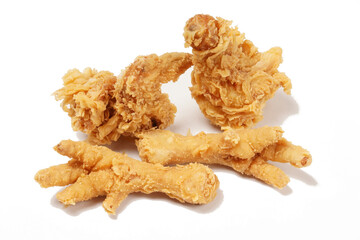 Golden fried chicken with a crispy, flour-coated skin, photographed against a white background.