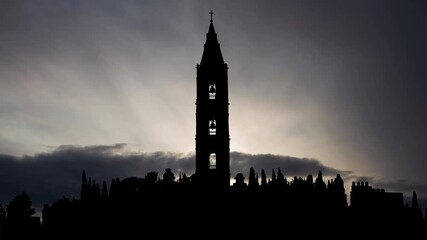 Mount of Olives in Jerusalem at Sunrise, Time Lapse with Fast Clouds and Dark Silhouette of  bell tower of Russian Orthodox convent, Israel
