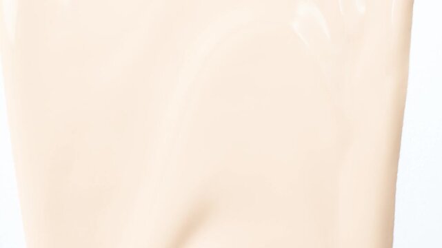 Flow foundation on a white background, art in cosmetics.