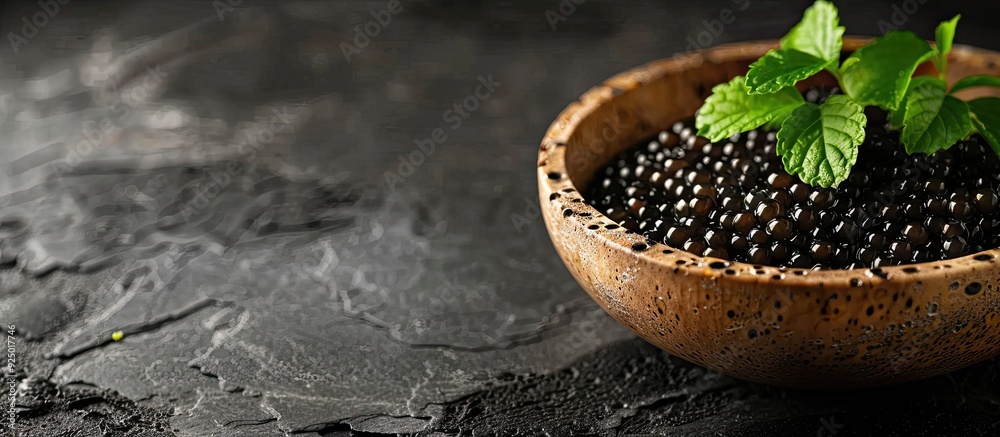 Poster A delectable fresh seafood appetizer of lumpfish black caviar displayed on the table with a food background and copy space image