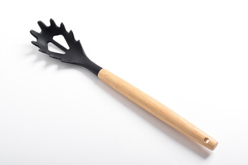 Black plastic spoon for draining of spaghetti isolated on white background
