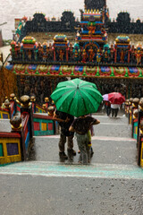 Tourists caught under the rain on the staircase to Batu Caves nea Kuala Lumpur, Malaysia