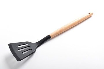 Kitchen spatula on isolated white background. Black silicone spatula with wooden handle. Cooking utensil
