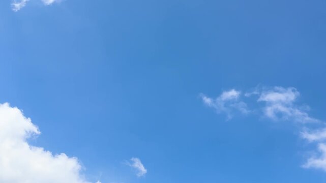 Time Lapse Blue sky with white clouds and a bird flying. Perfect for naturethemed designs, backgrounds, travel websites, and inspirational content.