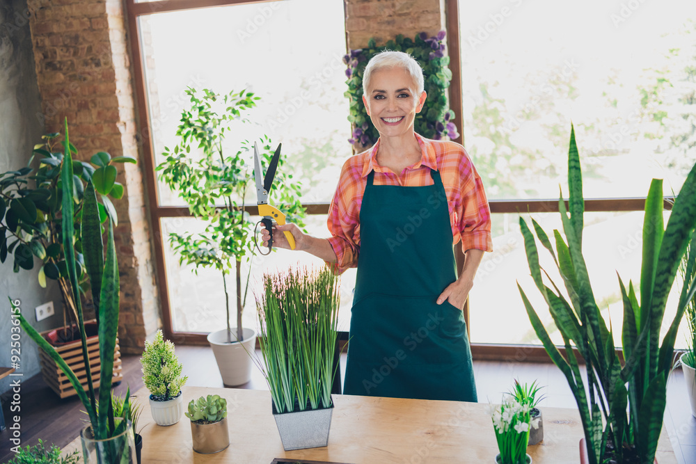 Canvas Prints Photo portrait of pretty senior female professional florist hold secateurs houseplant care wear apron working flower shop delivery