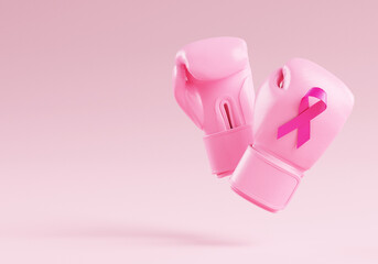 Pink boxing gloves with a breast cancer awareness ribbon on a pink background and copy space for banner design template. Pink October for the fight against breast cancer