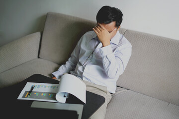 Young asian business man massaging rubbing stiff sore neck and headache tensed muscles fatigued...