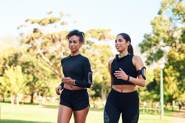 Friends, girls and fitness with jog in park in happiness for workout and running in Atlanta. People, runner and smile or confident with exercise for health, wellness and self care on race in forest